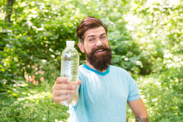Drink Plenty Of Water. drinking water in forest outdoor with sunset nature on background. Bearded man with water bottle. fitness portrait of bearded man. happy mature guy. thirsty hipster traveler