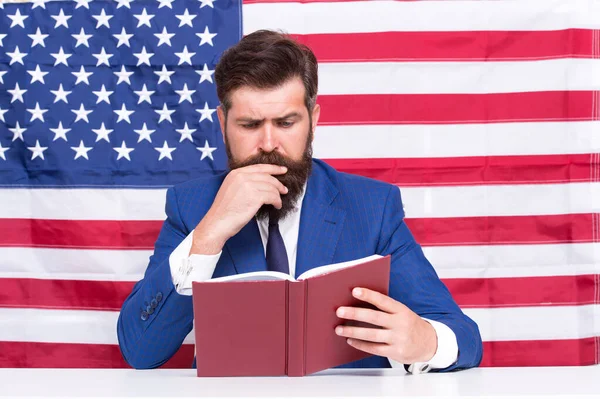 Read explanation to learn more. Teacher read book on USA flag background. Teaching to read. Literacy study. School and education. Language courses. American English. Read and understand