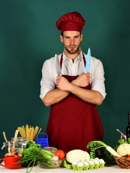 Mannen i kock uniform. Chef med självsäkert ansikte håller knivar — Stockfoto
