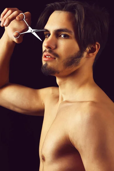 Bearded macho with scissors on black background — Stock Photo, Image