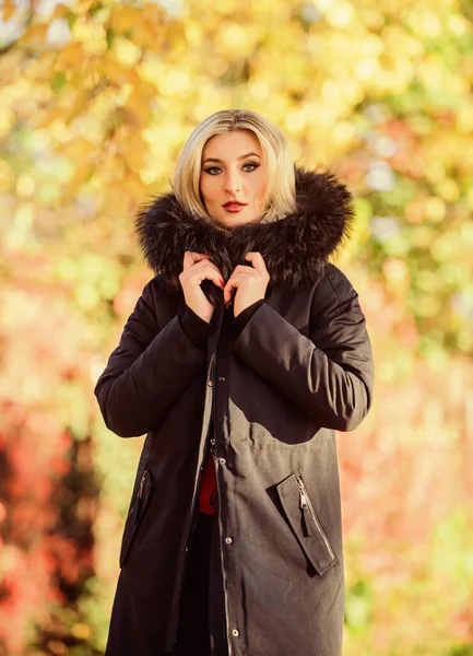 Classic parka coat has become wardrobe icon. Versatile functional and stylish. Girl wear parka while walk park. Autumn season fashion concept. Puffer jacket with hood. Woman wear black parka fur hood