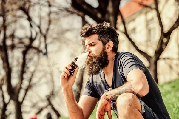 Perfect style. Health safety and addiction. inhaling vapor. man smoking e-cigarette. Mature hipster with beard. Bearded brutal male smoking electronic cigarette. hipster man hold vaping device