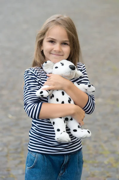 Best friends. Happy kid embrace toy dog outdoors. Childhood friends. Play and imagination. Friends and friendship. Relationship and relations. Child development. Kindergarten and playschool