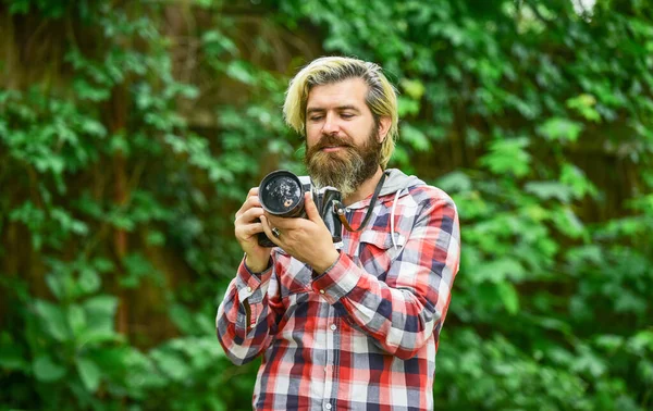 Use camera. Creating content for blog. Bearded man hipster taking photo. Photographer and vintage camera. Man with retro camera. Photography in modern life. Hobby and professional occupation — Stock Photo, Image