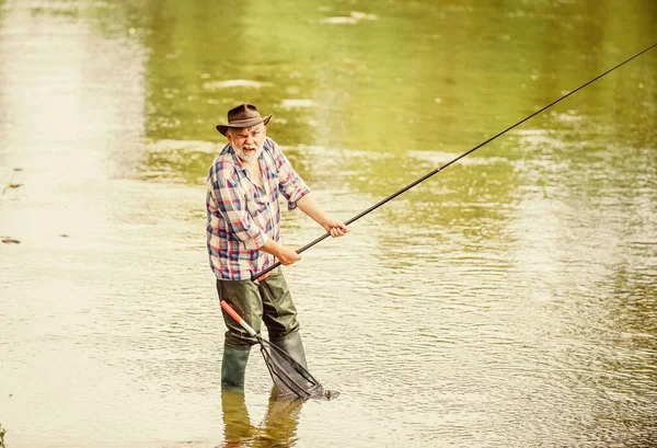 If wishes were fishes. hobby and sport activity. pothunter. retired bearded fisher. Trout bait. summer weekend. Big game fishing. mature man fly fishing. man catching fish. fisherman with fishing rod — Stock Photo, Image