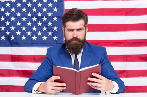 Book for mastering american english. Bearded man read book on USA flag background. Reading book. Vocabulary and grammar. Knowledge and information. Library and bibliotheca. Teachers book