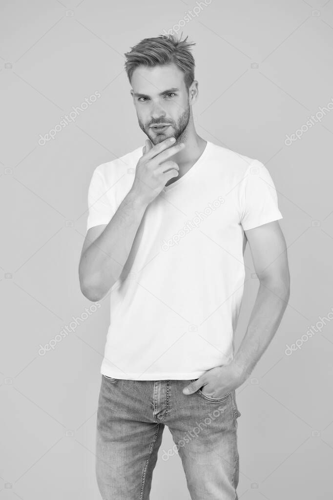 Summer vibes. sexy man on yellow background. male beauty style. charismatic fashion model. casual summer outfit. young serious student. barbershop concept. handsome guy with light unshaven