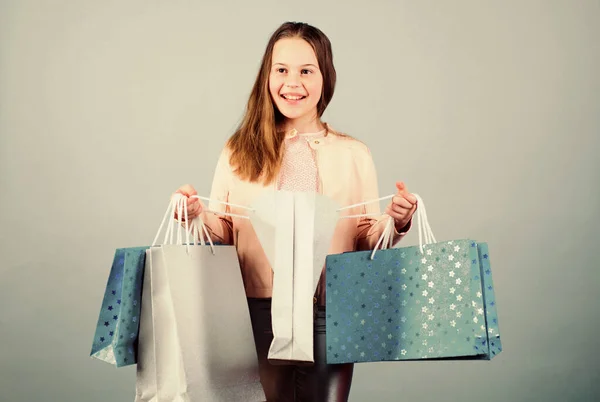 Compras exitosas. Moda infantil. asistente de tienda con paquete. Feliz niña. Niña con regalos. Ahorro de compra vacaciones. Ventas y descuentos. Niña pequeña con bolsas de compras. sensación de éxito —  Fotos de Stock