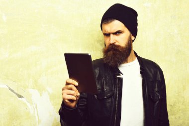 Sakallı, Kafkas hippisi, duvarın arka planında parçalanmış bir tablet taşıyor.