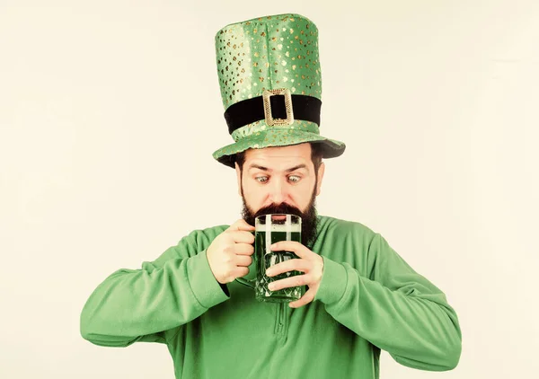 Green beer part of celebration. Irish pub. Alcohol consumption integral part saint patricks day. Irish culture. Man bearded hipster funny hat drink pint beer. Cheers concept. Colored green beer