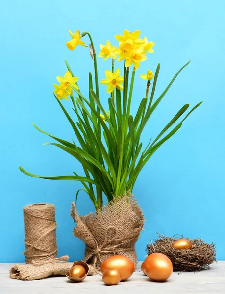 Spring yellow narcissus, golden easter egg and thread or rope — Stock Photo, Image