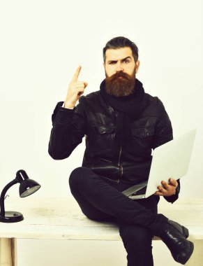 Masada dizüstü bilgisayarla oturan vahşi beyaz hippi.