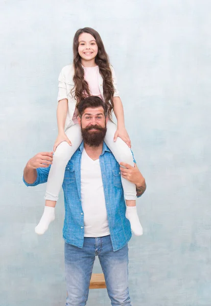 Do what you like. Baby girl enjoy active game with father. Bearded man piggyback small child. Casual look of happy family. Casual wear. Fashion trends. Trendy style. Hair salon. Barbershop