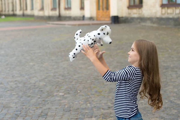 Life full of fun. Happy kid play with toy dog outdoors. Enjoying playtime. Play and fun. Childhood fun. Leisure and free time. Active games. Summer vacation. International childrens day, copy space