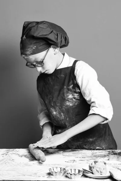 Stained cute cook chef boy on red studio background — Stock Photo, Image