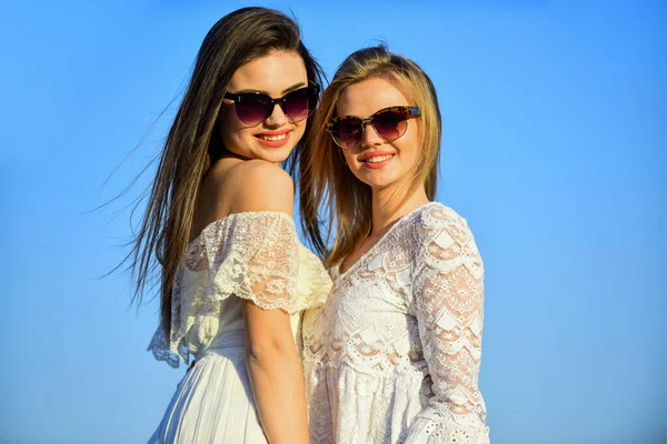 Joint trip. Summer outfit. Portrait of the beautiful girls. beach fashion style. Summer outdoor lifestyle. Happy young friends posing over blue sky. pretty young beautiful women in sunglasses