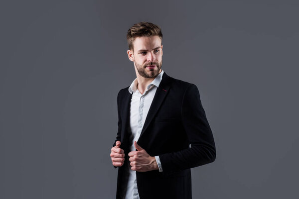 Portrait of a handsome CEO. Businessman in suit. Young handsome man. Young manager in his office. portrait of a businessman on grey background. confident businessman portrait