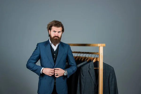 My choice. Handsome bearded fashion man in classical costume suit. Man in custom tailored suit presenting expensive tailored tuxedo. Man clothing in boutique. Man with suit. tailor in his workshop — Stock Photo, Image