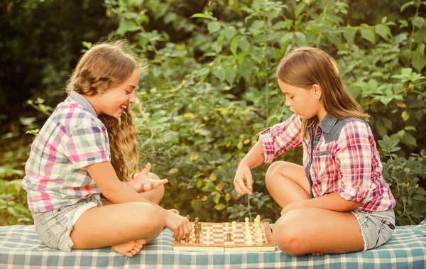 thinking process. early childhood development. worthy opponents. develop hidden abilities. two girls play chess. chess playing sisters. skilled children. turn on your brain. make the brain work