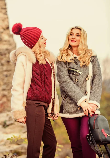 Fall outfit. Beautiful ladies walking in warm clothes. Gorgeous girls.  Beauty and fashion concept. Difference between faux and real fur. Visual  aesthetics. Benefits wearing fur. Women wear fur coats Stock Photo by ©