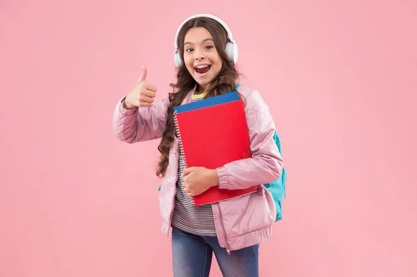 Perfect learning. Happy child give thumbs up pink background. Approval gesture. Hand sign. Little girl back to school. English language courses. Private teaching. New technology. Be better future