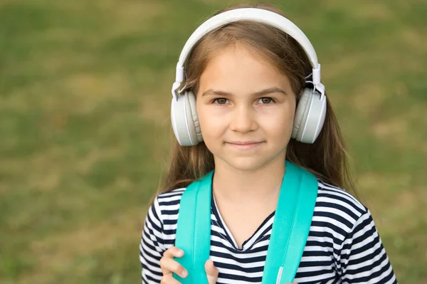 English is meant to learn. Small kid wear headphones. English school. Language education. Listening skills. New technology. Private teaching. Online courses. Learn English by listening, copy space