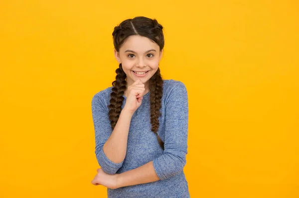 Portrait de fille heureuse souriant. jeune belle fille souriante avec coiffure à la mode. enfant insouciant posant sur fond jaune. Des émotions positives. salon de coiffure pour enfants — Photo