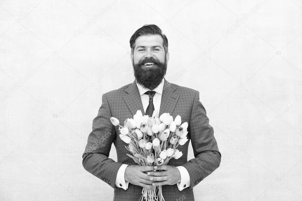 Hello summer. bearded man in formal suit greeting. happy valentines day. womens day gift tulips. spring flowers. Man with bouquet tulips. prepare for mothers day holiday. flower surprise for her