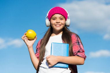 Vejetaryen tercihi. Mutlu çocuk güneşli mavi gökyüzünde elma tutuyor. Sağlıklı beslenme alışkanlıkları. Meyve çerezi. Vejetaryen yemeği. Okul tatili. Dinlemek ve okumak. Ses kitabı. Vejetaryen diyeti. Her lokma önemli