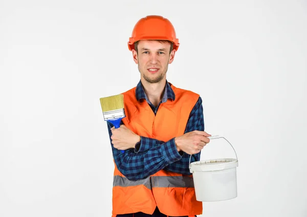 young man in hard hat. man builder use paiting brush. repairman in helmet. build and construction. skilled architect repair and fix. engineer worker career. tools for repair. This will be perfect