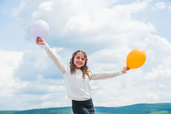 Fly with helium balloons. Higher and higher everyday. Cheerful girl have fun. Freedom concept. Happiness is air balloons. Summer holidays and vacation. Childhood happiness. Happiness concept