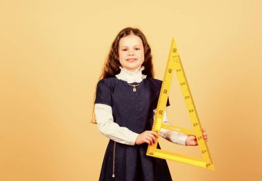 Matematik dersi. Eğitim ve bilgi. Küçük kız okula geri döndü. Okul öğrencisi geometri öğreniyor. Büyük cetveli olan öğrenci kız. BTMM okul disiplini. Eğitim ve eğitim