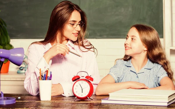 Es ist Zeit, wieder zur Schule zu gehen. Lehrer und kleines Kind beim Unterricht. Hübsche Frau und kleines Mädchen in der Schule. Während der Unterrichtszeit. Schulzeit. Privatunterricht. Bildung — Stockfoto