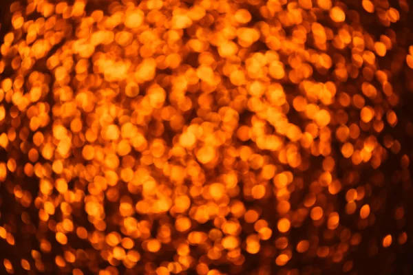 Bokeh op goud oranje gedecentreerd licht. Abstract decoratieve gouden achtergrond — Stockfoto