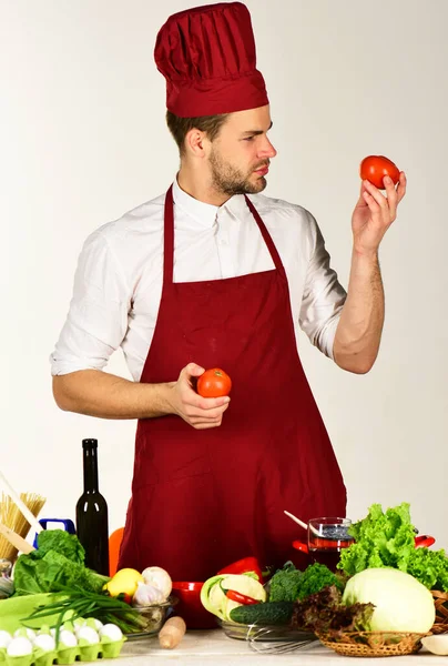 Homem em chapéu de cozinheiro e avental contém ingredientes — Fotografia de Stock