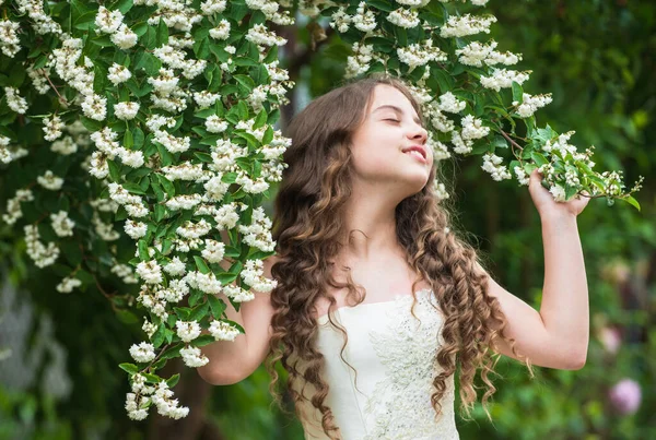 Dreams come true. girls party dress. female fashion salon. little beauty in blossoming garden. park jasmine flower. beautiful prom queen. look as princess. bridesmaid. childhood happiness