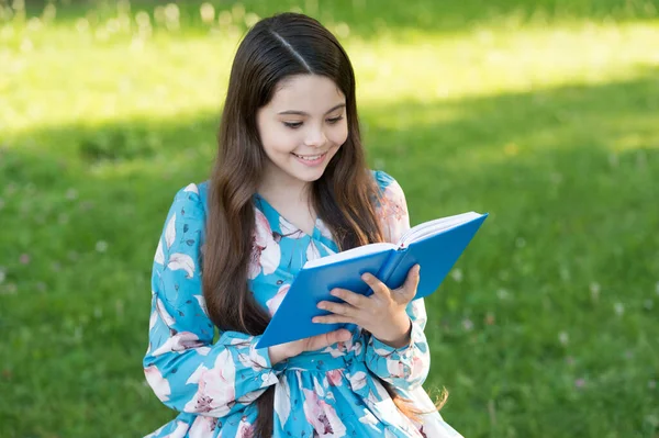 Gyermek lány pihentető szabadban könyvvel, izgatott olvasás koncepció — Stock Fotó