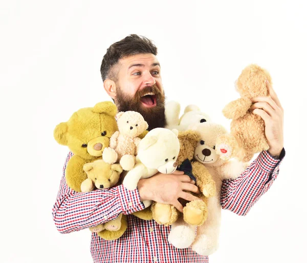 Homem com cara feliz abraços ursinhos de pelúcia ou brinquedos macios. — Fotografia de Stock