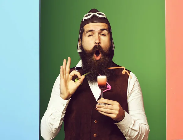 funny handsome bearded pilot on colorful studio background