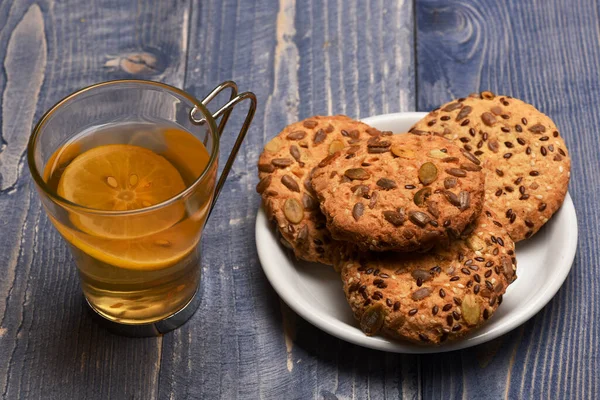 Traditional snack for tea time. Biscuits with seeds near tea — Stock Photo, Image