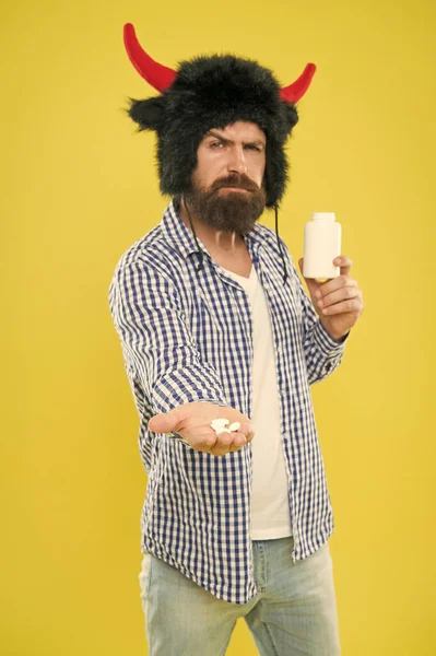 Male health concept. Mature man with pill bottle. Vitamin complex. Dieting and health care. Medical treatment. Healthy as bull. Bearded man holding vitamin container. Vitamin supplements for men
