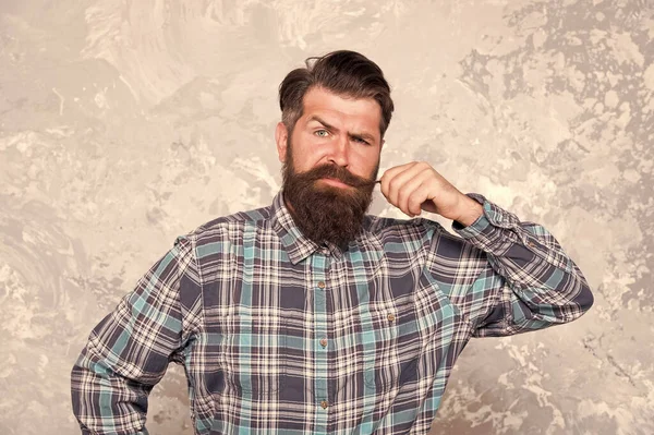 Portrait of masculinity. Stylish fashionable man grunge background. Handsome man wearing checkered shirt. mature hipster touch his moustache. hairdresser and barbershop. hair and beard care — Stock Photo, Image