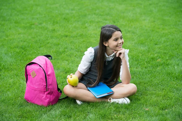 Your health is your wealth. Happy child relax on green grass. Healthy snack. School break. Health education. Natural diet. Dental health. Oral hygiene. Dental care habits. Child care and health — Stock Photo, Image