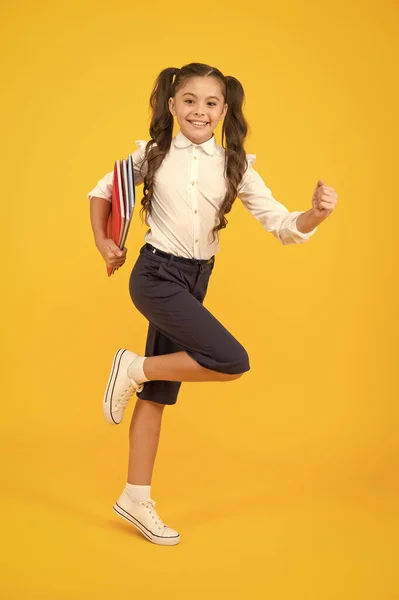 Hurry up. Keep going. Active kid. Girl with books on way to school. Knowledge day. Back to school. Kid cheerful schoolgirl running. Pupil want study. Active child in motion. Beginning school lesson
