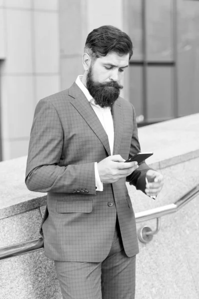 Contact list. Online business. Bearded man with smartphone. Handsome cool businessman using smartphone. Send message. Audio message service. Text messaging. Mobile communication. Email message