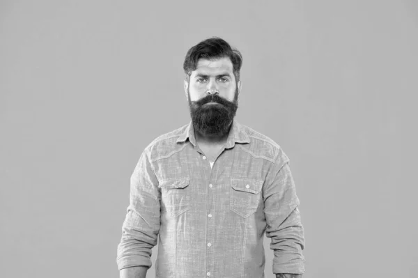 In his own style. Serious man orange background. Bearded man in casual denim style. Menswear store. Caucasian man wear mustache and beard. Hipster look of brutal man. Barbershop — Stock Photo, Image