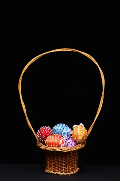 Eggs decorated with bright color threads and beads in pottle — Stock Photo, Image