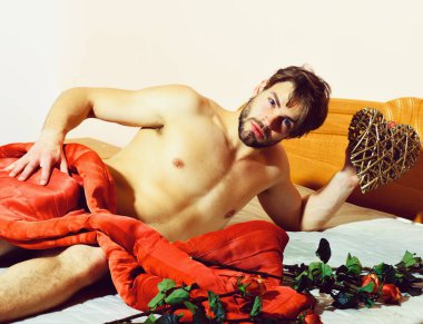 Sakallı, maço, mavi duvarlı bir adam.