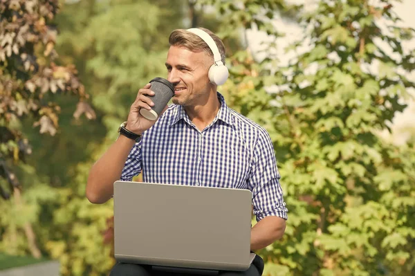 Podcast business development. Podcast for manager. Musical service. Handsome man listening podcast while work with laptop. Always studying. Online communication. Personal blog social networks — Stock Photo, Image