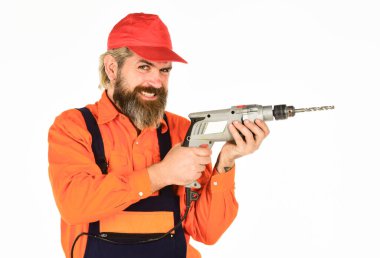 Duvarı delmek için taş ustası olmak lazım. Beyaz arka planı delinmiş şapkalı bir adam. Perforatör ve ısırık. Güçlü matkap. Matkap al. Tamirci delik açıyor. Güvenlik önlemleri. Sondaj konsepti